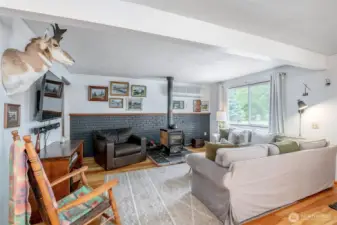 Large window framing views of the lush outdoors, and provides ample natural light to the space.