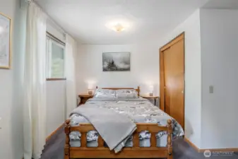 Spacious main-level bedroom with cozy (new!) carpet underfoot  and a bonus office / seating area—perfect as a private retreat or flexible guest space.