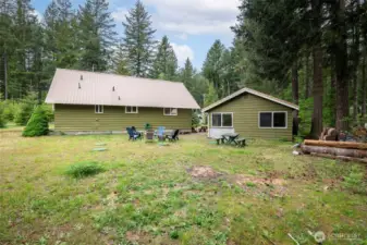 Backyard view showing both the main house and detached garage.
