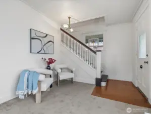 Notice the period light fixture in the entry and the beautiful, gracious open stairs and railings.