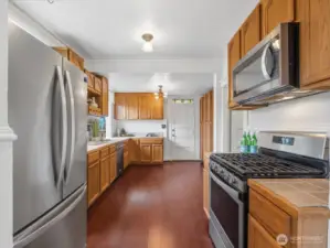 This kitchen has more than adequate storage. The door leads to the backyard.