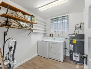 Great storage space in the utility room. The washer and dryer will stay with the house.
