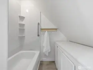 The upper level full bathroom with linen storage cabinet.