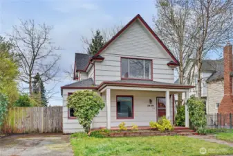 Classic North End Tacoma home with original exterior details, mature landscaping, and a covered front porch, offering strong curb appeal and an opportunity for buyers looking to personalize a property with vintage character.