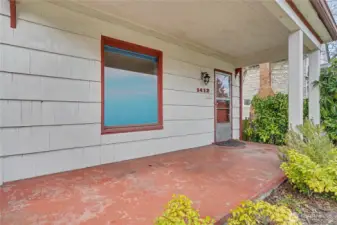 Covered front porch providing a welcoming entry and a glimpse into the home’s long-preserved charm.
