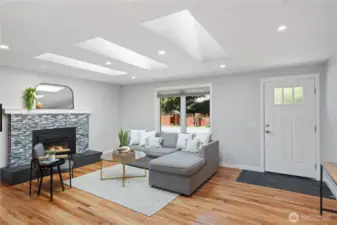 Living room with propane fireplace and skylights