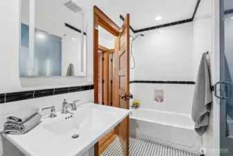 Across from second bedroom, full bathroom with nice size pedestal sink and private bathroom and shower.