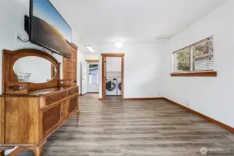 Laundry room with gas washer and dryer, beautiful flooring.