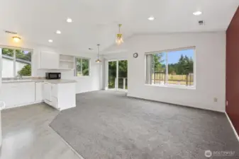 Large Living area! Dining room in the background with Sliding glass door to the wrap around deck!