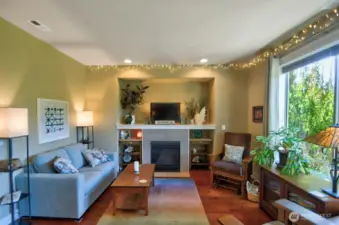 Living room features natural gas fireplace, space for theater sized TV above, large picture windows with fabulous territory views.