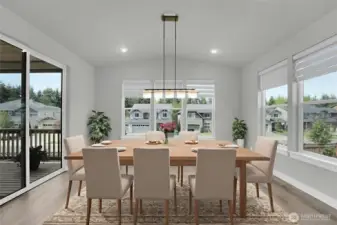 Sunroom style dining room with custom lighting, electronic Hunter Douglas window coverings. Opens to covered deck.