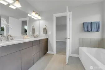Primary bath with double sinks, walk-in shower and soaking tub.