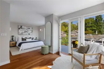 Expansive primary suite on the 3rd floor framed by windows.