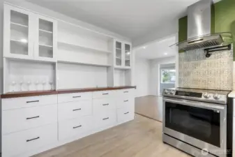 This cabinet in the kitchen offers plenty of additional storage, may be used as a coffee bar. It isn't attached and transfers with sale.