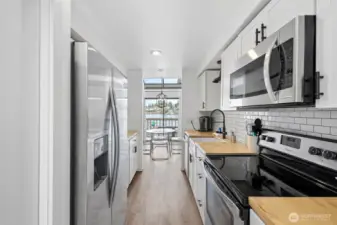 Remodeled kitchen with farmhouse sink & stainless appliances