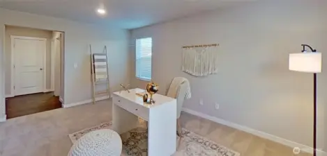 Main-level den/office/bonus room. Staged.