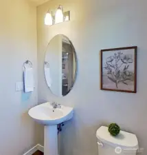 Main-level half bath. Staged.