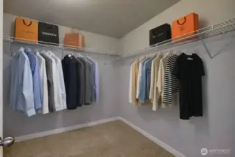 Primary closet. Virtually staged.