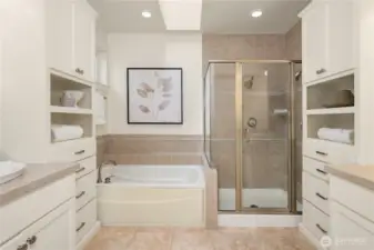 Primary bath with seperate vanites, soaking tub, shower and walk in closet