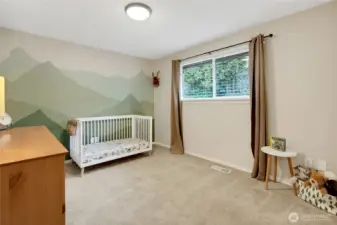 PNW themed room with hand painted mountains, plush carpets and clean lines, this room also has a view of the terraced backyard!