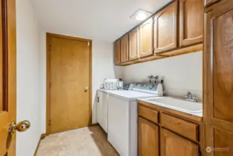 Spacious laundry room, with utility sink and lots of storage!