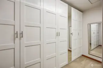 Your dream walk in closet has gorgeous built-ins with mirror accent to organize your entire wardrobe just off of the primary suite bathroom.