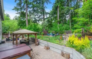 This amazing back yard has it all!  Multiple seating areas, hot tub, water feature, gas firepit, wood burning firepit and privacy!  Truly an outdoor paradise!