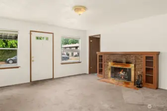 Enter to spacious living room with fireplace