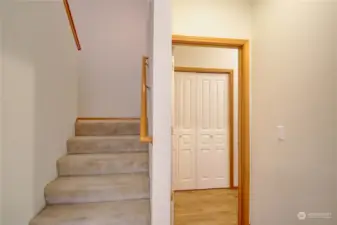 Stairwell to upstairs. Doorway to the right leads to laundry room