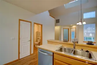 Kitchen showing guest bath and pantry door