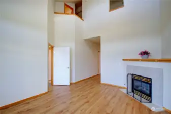 Living room fireplace looking up to loft area on 2nd floor