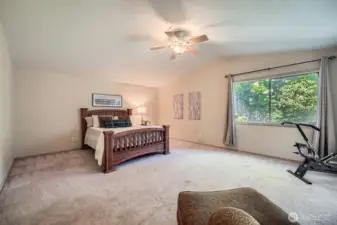 Bright and Spacious Main Floor Room  Featuring vaulted ceilings and a sliding door that opens directly to the back deck and hot tub, this versatile main floor space—currently used as a bedroom—offers an inviting blend of indoor comfort and outdoor access. Perfect as a bonus room, family room, or your personal retreat.