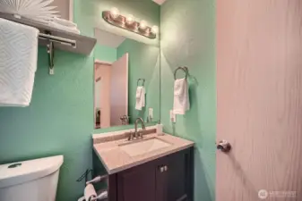 This well-appointed half bath offers essential convenience with a sleek sink and modern toilet—perfectly designed for guests or quick use.