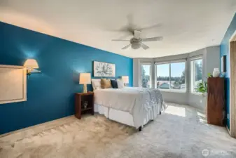 Primary Bedroom with Charming Bay Window  The spacious primary bedroom features a beautiful bay window that floods the room with natural light and creates the perfect spot for a cozy reading nook or quiet reflection.