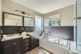 Updated Primary Bathroom  Relax and unwind in the beautifully updated primary bathroom, featuring a luxurious soaking tub and a stylish tile shower with a sleek glass enclosure—combining comfort and modern design.