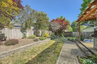 Beautifully Landscaped Backyard  Enjoy a spacious, beautifully landscaped backyard featuring a large shed for extra storage and a charming paver walkway that adds both function and curb appeal.