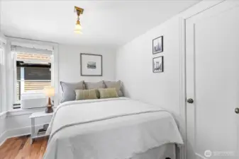 Bright and fresh bedroom with closet, hardwood floors and natural light.