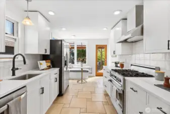Freshly updated kitchen with new  designer backsplash, counters, Gas stove/range and tile floors.