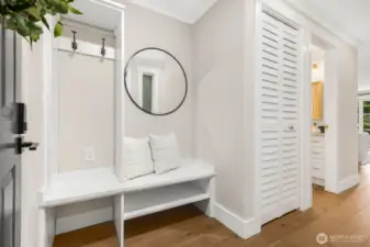 Step inside to a bright, welcoming entry with a built-in bench and storage nook, perfect for everyday organization.