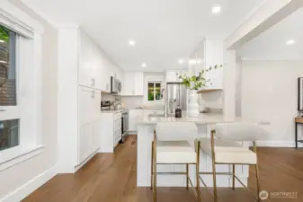 The open layout with breakfast bar seating connects seamlessly to the dining and living spaces, perfect for everyday living and entertaining.