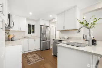Every detail shines in this remodeled kitchen, from the sleek stainless appliances to abundant storage space.