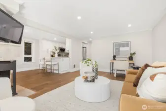 Another view of the living area showcasing fresh paint, new floors, and a flexible layout.