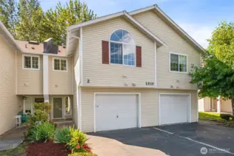 The townhome is on a quite dead-end street offering a welcoming entrance with flowering perennials.