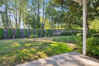 The private backyard provides a natural backdrop from the interior of the home.