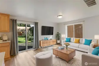 Spacious family room virtually staged off kitchen with sliding doors to expansive patio.