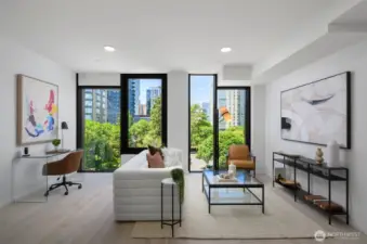 Living area features operable floor-to-ceiling windows, engineered hardwoods, ceiling Mitsubishi mini-split, and ample space for a home office.