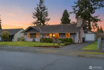 Beautiful twilight exterior captures the home’s inviting curb appeal and warm evening glow.