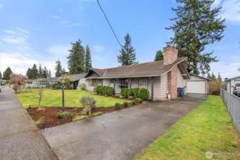 Spacious front yard with refreshed landscaping and a clean, welcoming presentation.