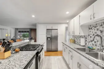 Bright and refreshed kitchen featuring stainless steel appliances, granite countertops, ample cabinet storage, and modern finishes.