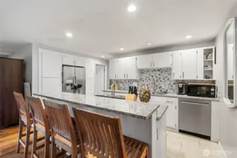Breakfast Bar -   Oversized breakfast bar with granite counters, abundant seating, and a great open connection to the updated kitchen.